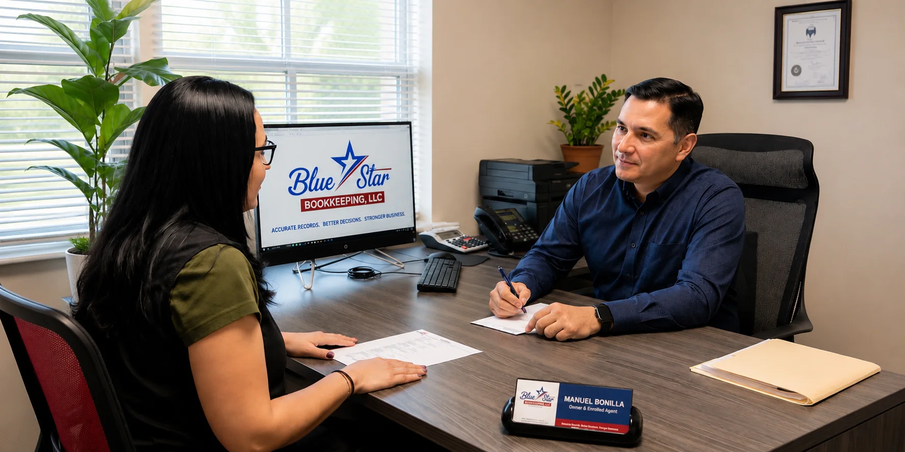 Manuel Bonilla helping a client during a consultation at Blue Star Bookkeeping in Austin